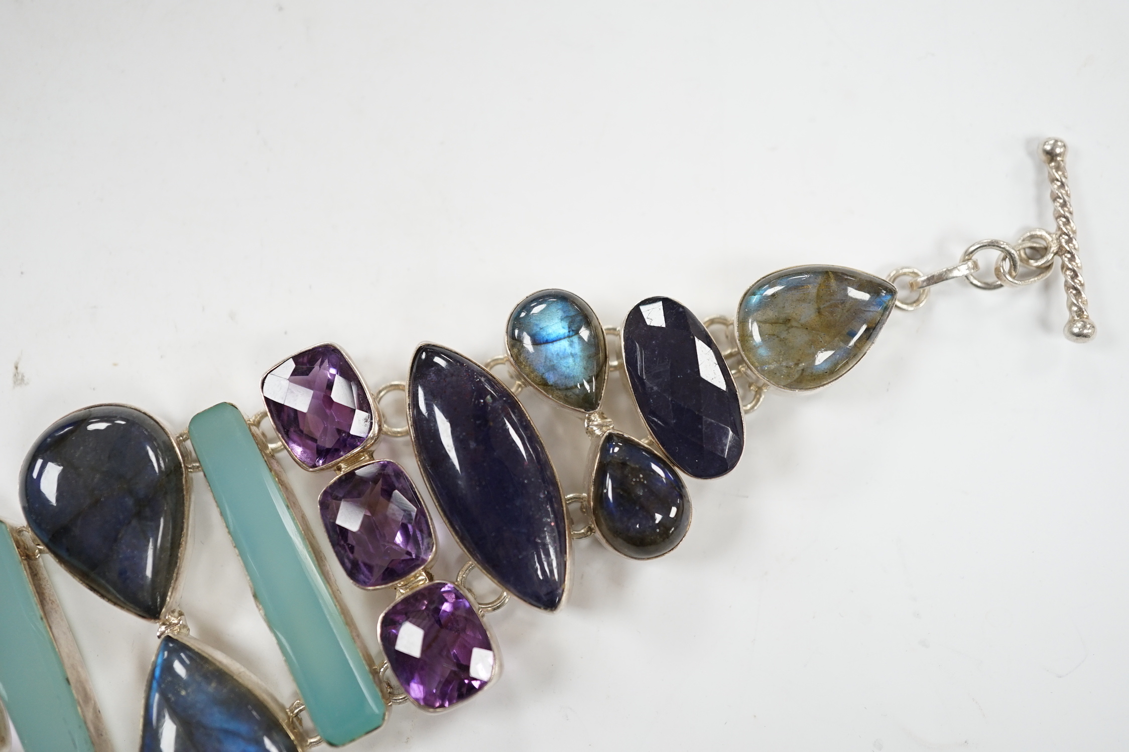A white metal and multi gem set bracelet, including dyed agate, amethyst and labradorite, 21cm.
